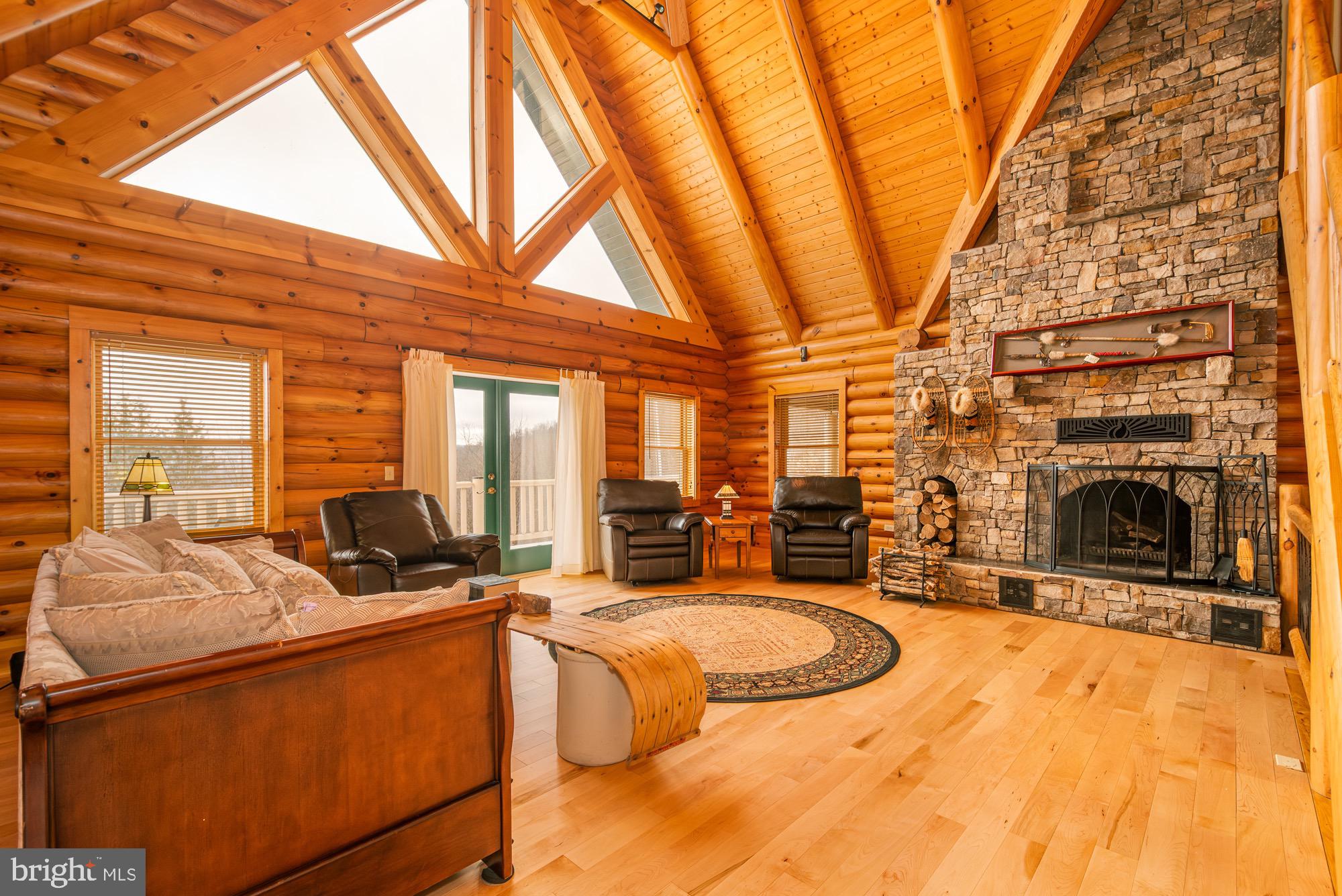 17051 Laurel Run Road Southwest Barton, MD 21521 - Photo 22 of 77 a view of a living room and kitchen with furniture and fireplace