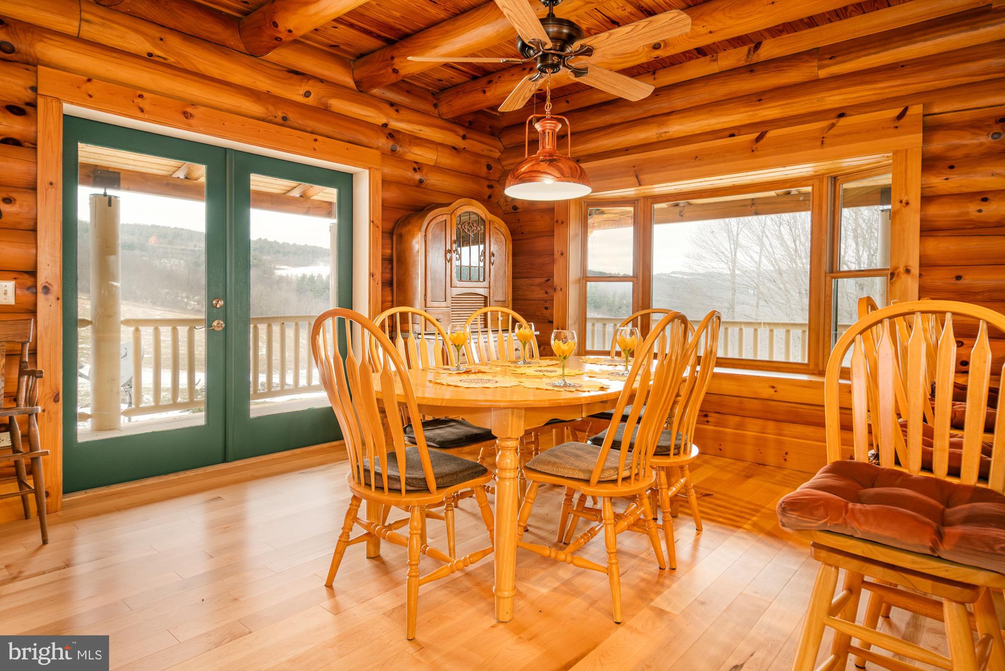 17051 Laurel Run Road Southwest Barton, MD 21521 - Photo 29 of 74 a dining room with furniture large windows and wooden floor