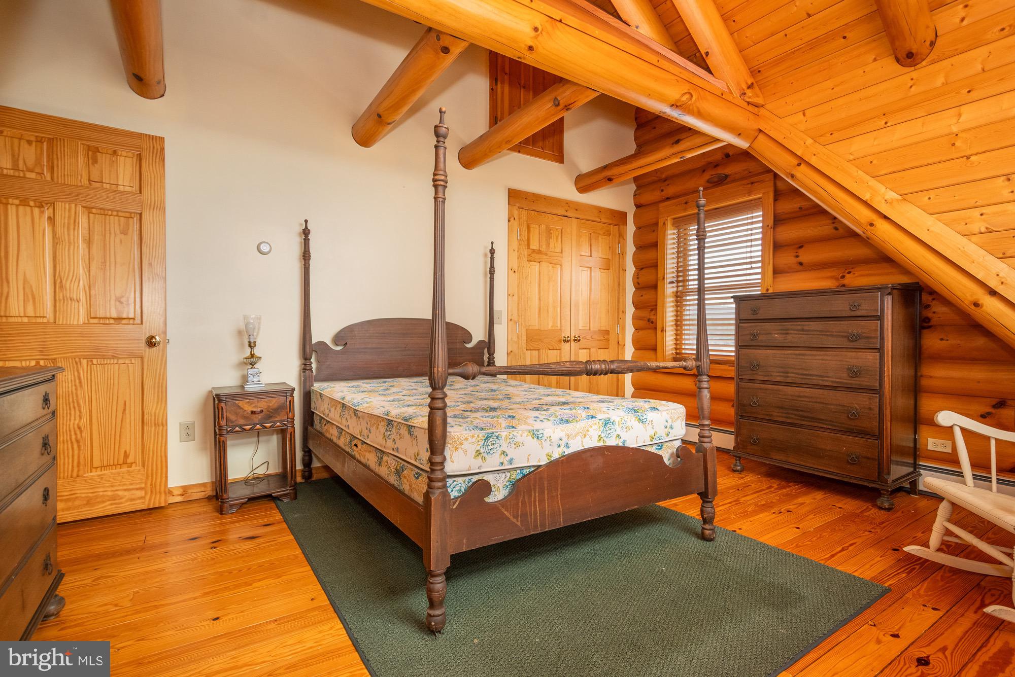 17051 Laurel Run Road Southwest Barton, MD 21521 - Photo 56 of 77 a bedroom with a bed and wooden floor