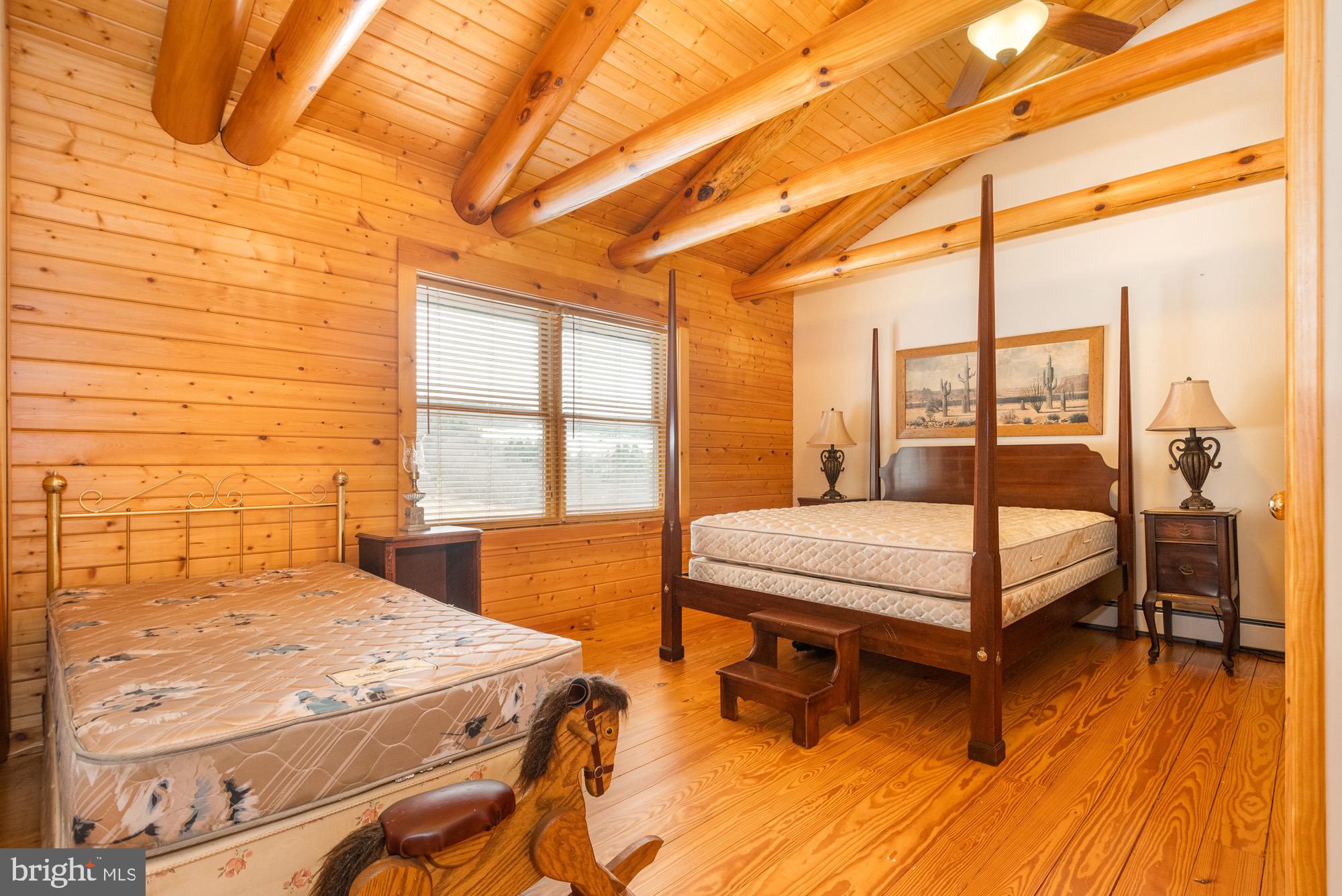 17051 Laurel Run Road Southwest Barton, MD 21521 - Photo 57 of 77 a bedroom with a bed a table and window