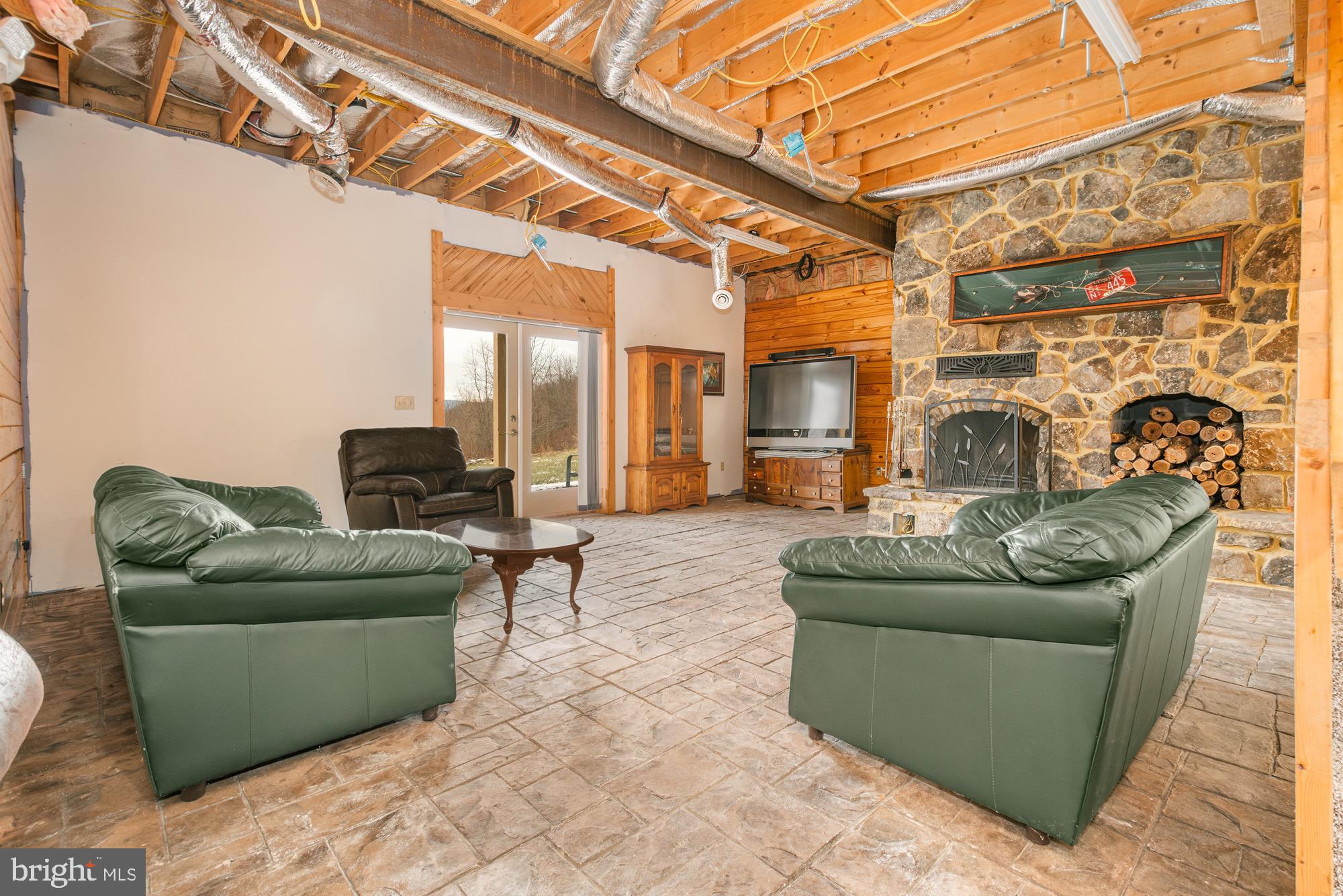 17051 Laurel Run Road Southwest Barton, MD 21521 - Photo 65 of 77 a living room with furniture and a fireplace