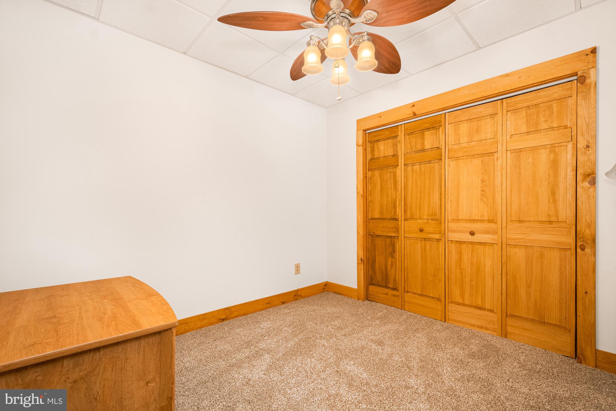 17051 Laurel Run Road Southwest Barton, MD 21521 - Photo 67 of 77 an empty room with a ceiling fan