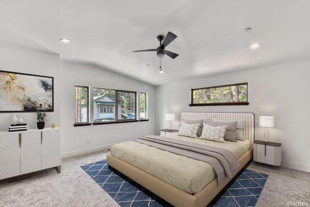 a bedroom with a large bed and a window