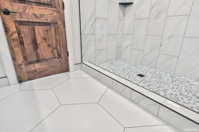 a bathroom with a granite countertop window and a shower