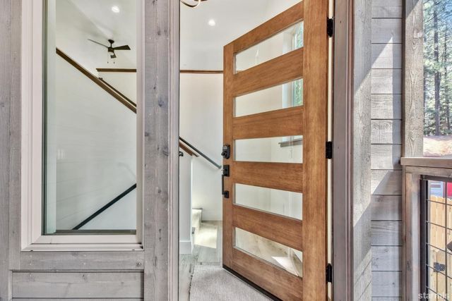 a view of staircase with wooden floor and a window