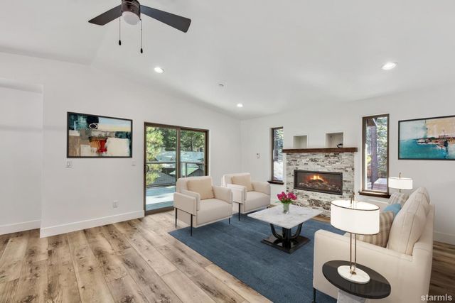 a living room with furniture a fireplace and a flat screen tv