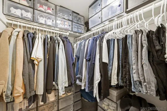 a view of walk in closet with clothes