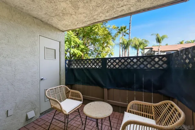 a balcony with table and chairs