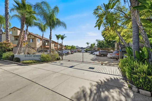 a street sign that is sitting in front of wooden building