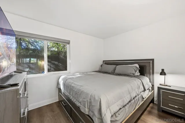 a bedroom with a bed and large window