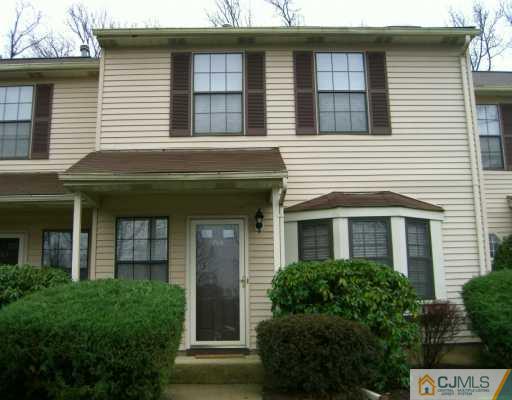 a front view of a house with plants