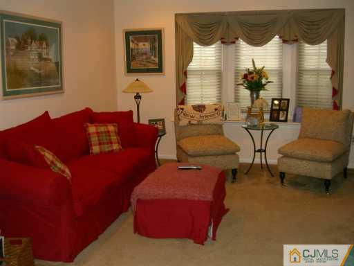704 Timber Oaks Road Edison, NJ 08820 - Photo 2 of 8 a living room with furniture and a wall painting