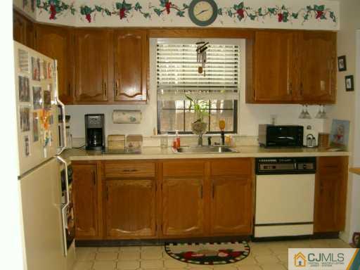 704 Timber Oaks Road Edison, NJ 08820 - Photo 4 of 8 a kitchen with stainless steel appliances granite countertop a stove and a white refrigerator