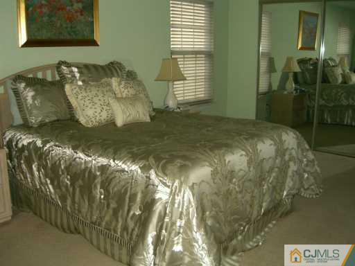 704 Timber Oaks Road Edison, NJ 08820 - Photo 6 of 8 a bed sitting in a bedroom next to a window