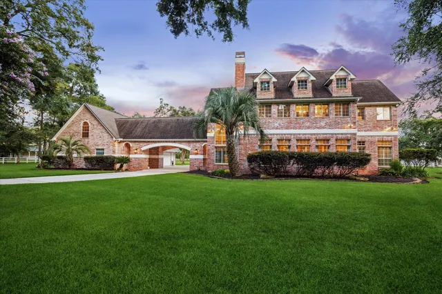a front view of a house with a garden and deck