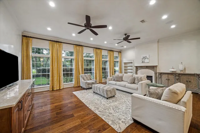 a living room with furniture ceiling fan and a flat screen tv