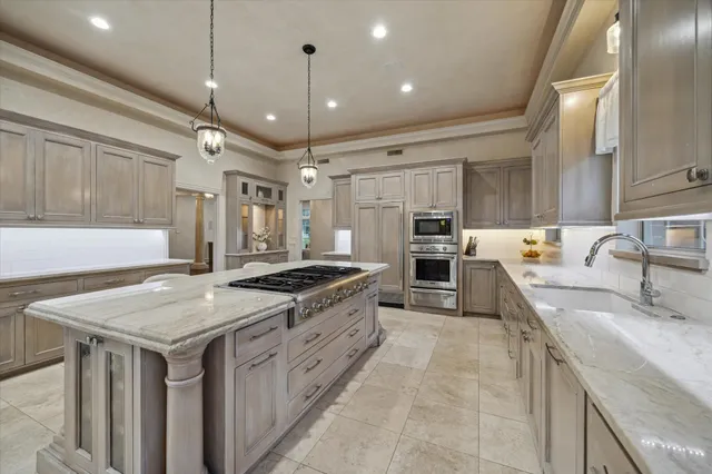 a kitchen with stainless steel appliances granite countertop a sink stove and refrigerator