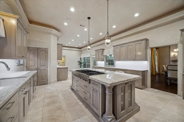 a kitchen with kitchen island a sink stove and refrigerator