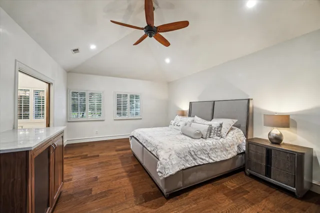 a bedroom with a large bed and a window