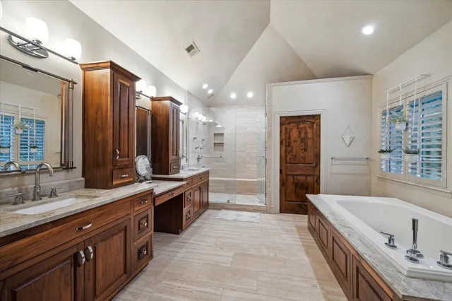 a large bathroom with a large tub sink and mirror