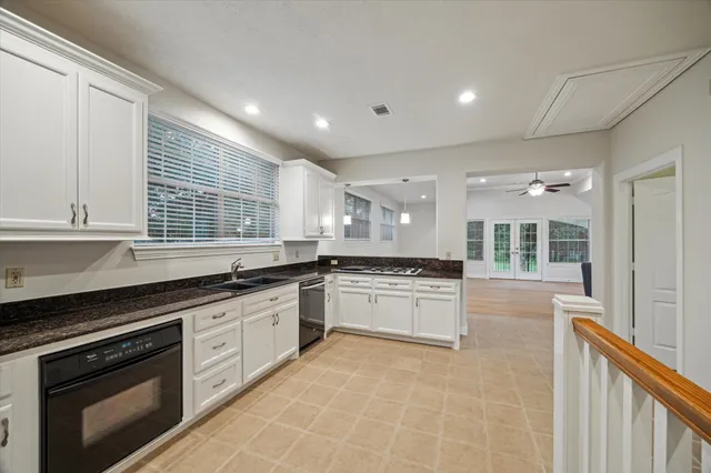 a large kitchen with granite countertop a stove and a sink