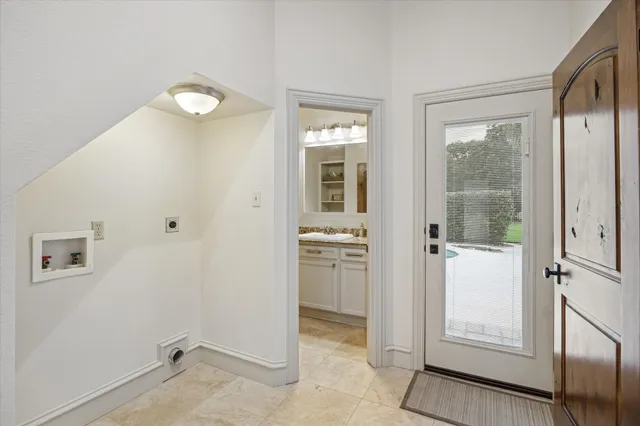 a view of a hallway with bathroom and wooden floor