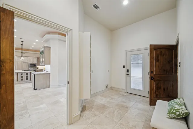 a view of kitchen with refrigerator and cabinets