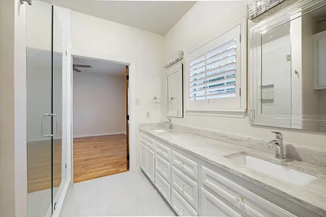 a bathroom with a granite countertop sink and a bathtub