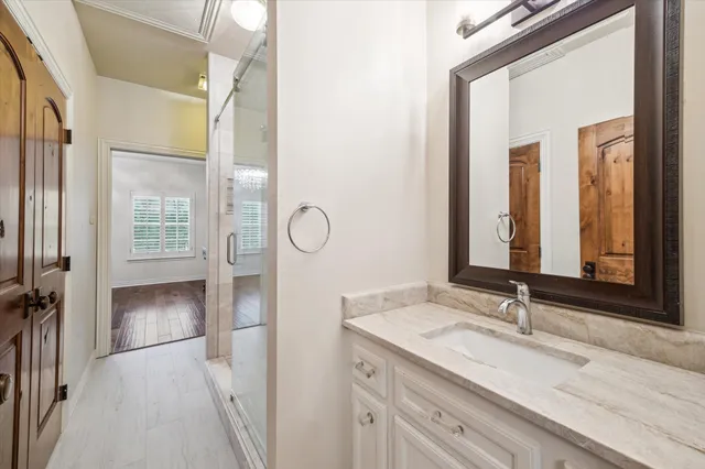 a bathroom with a granite countertop sink and a mirror