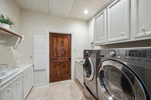 a utility room with sink dryer and washer