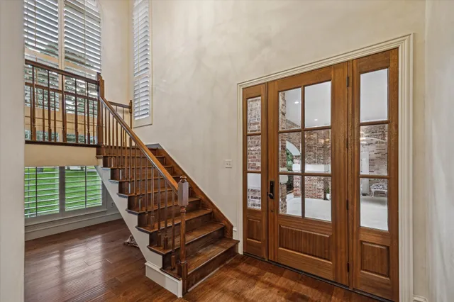 a view of entryway with wooden floor and windows