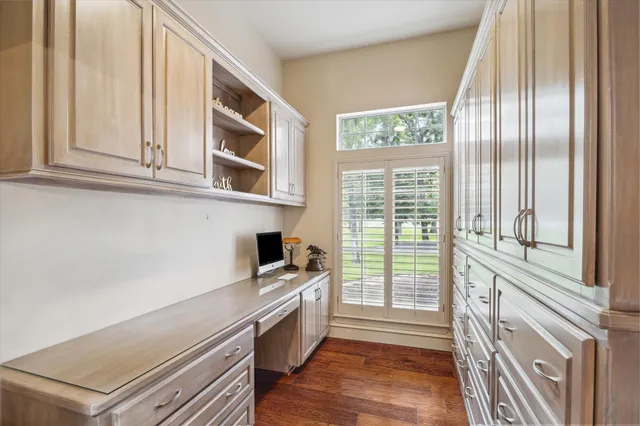 a kitchen with granite countertop a stove and a wooden floor