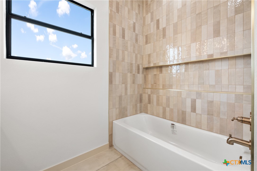 15121 Armstrong Ests Road Salado, TX 76571 - Photo 28 of 45 a bathroom with a bathtub and a shower