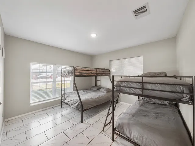 a bedroom with furniture and a window