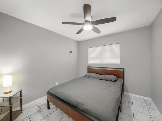 a bedroom with a bed and a window