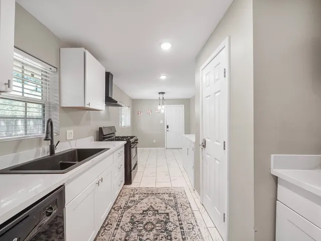 a kitchen with a sink stove and cabinets