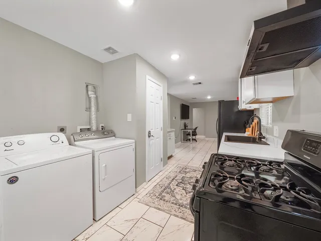 a kitchen with stove and cabinets
