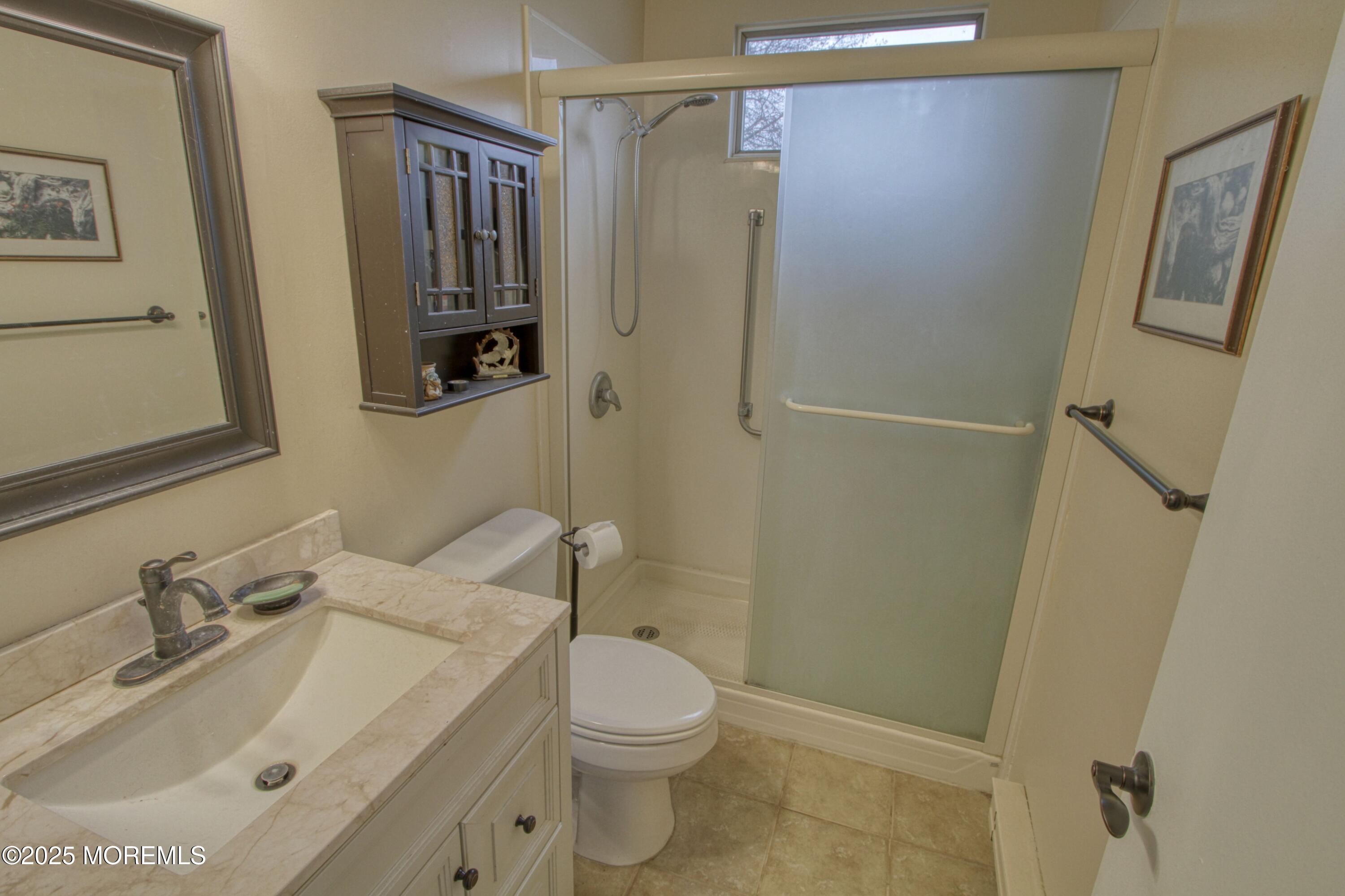 32 Augusta Road Whiting, NJ 08759 - Photo 11 of 30 a bathroom with a sink a toilet and shower
