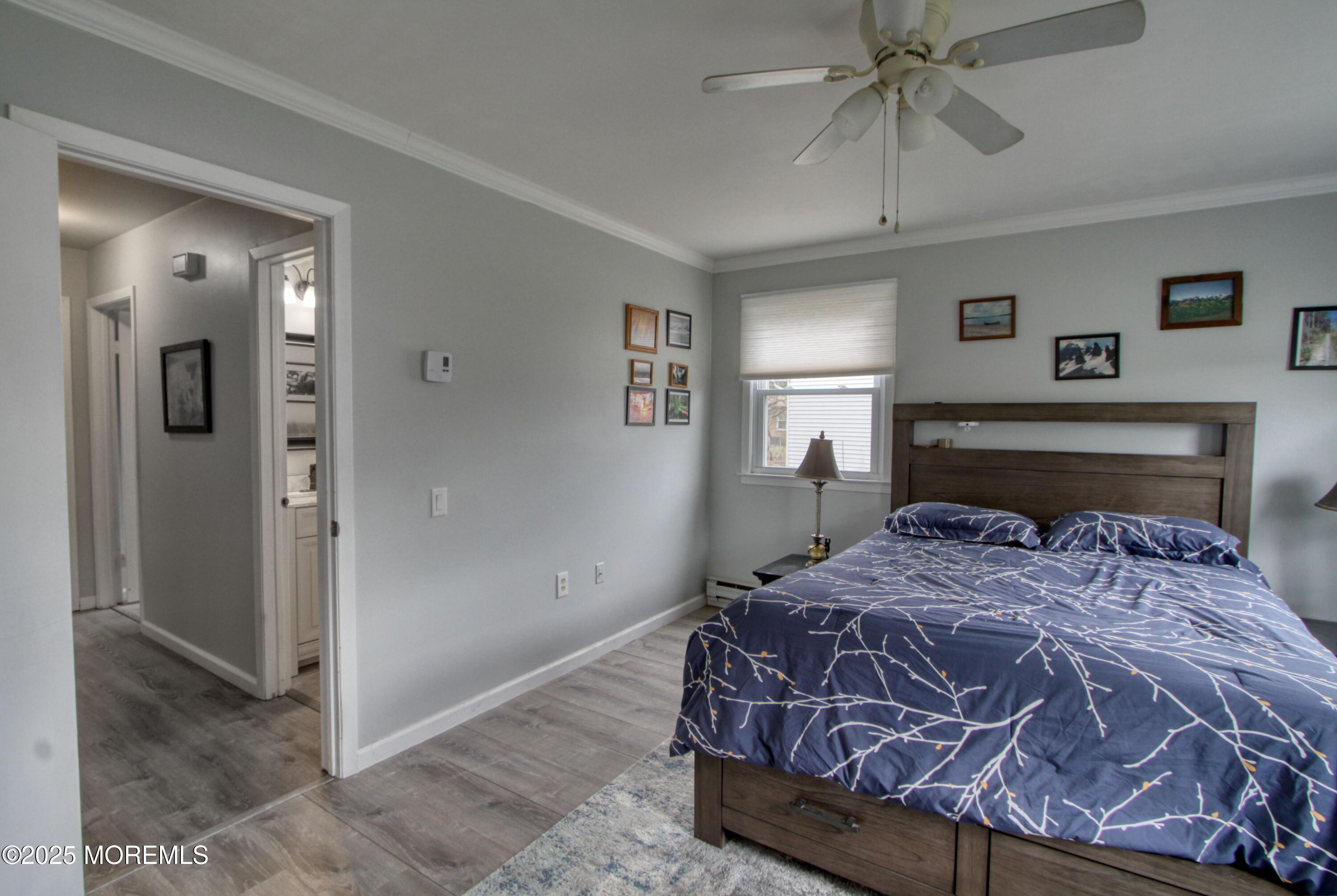 32 Augusta Road Whiting, NJ 08759 - Photo 12 of 30 a bedroom with a bed and a chandelier