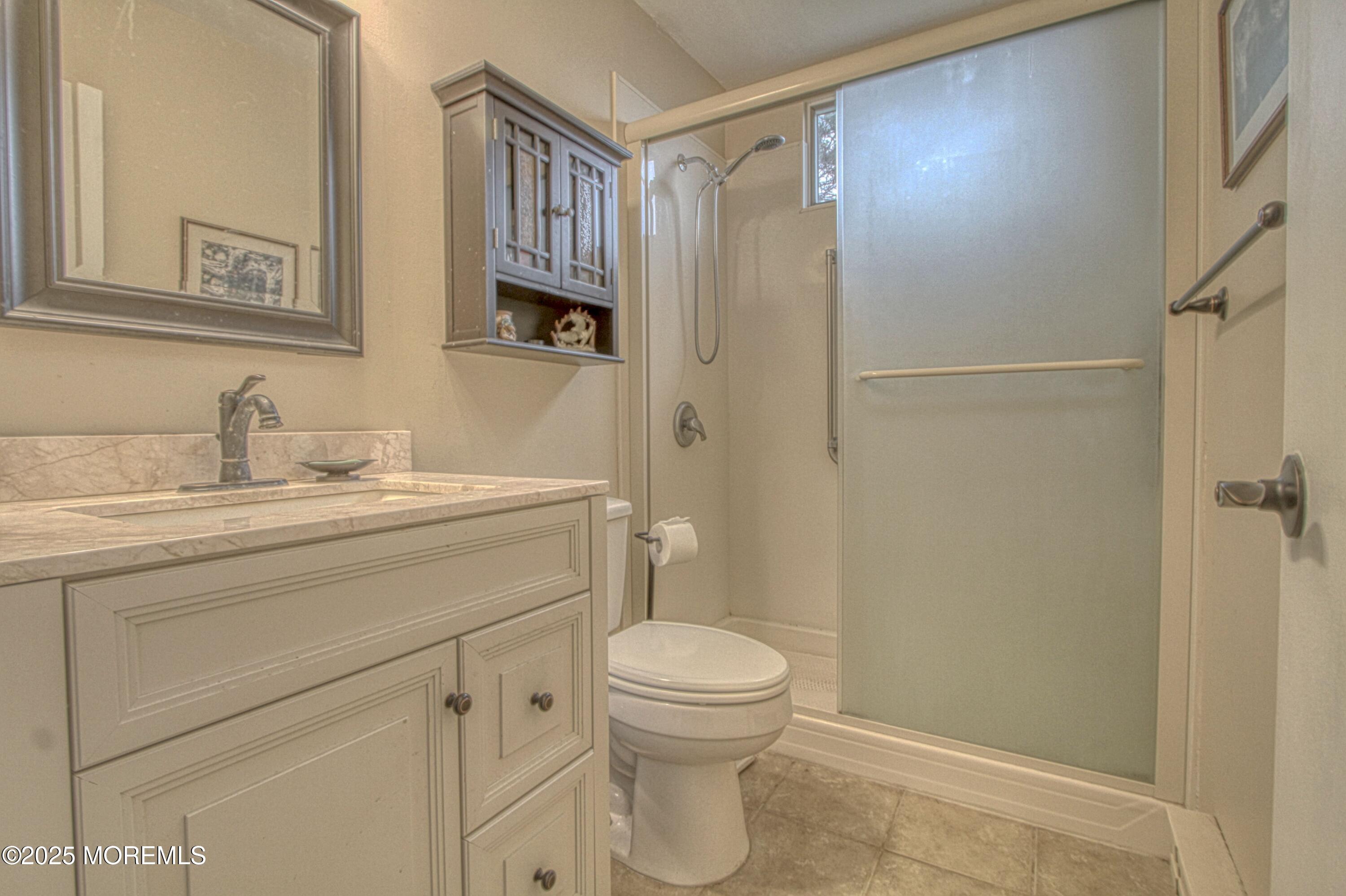 32 Augusta Road Whiting, NJ 08759 - Photo 13 of 30 a bathroom with a sink a toilet and shower