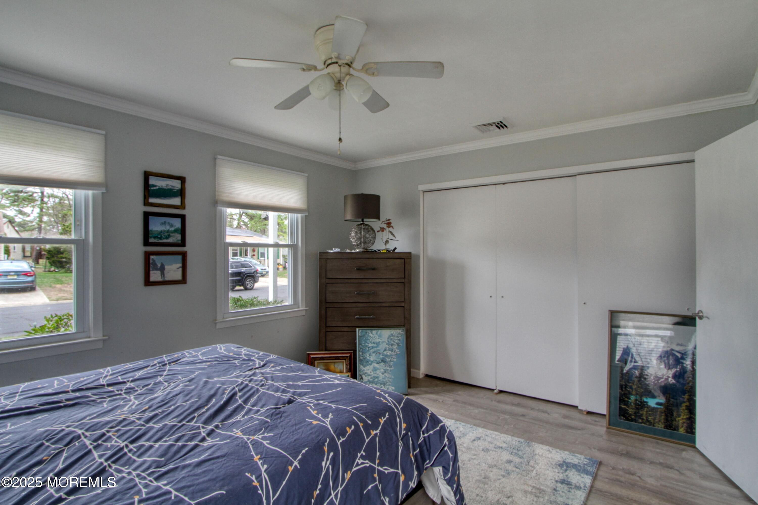 32 Augusta Road Whiting, NJ 08759 - Photo 14 of 30 a bedroom with a bed a dresser and a chandelier