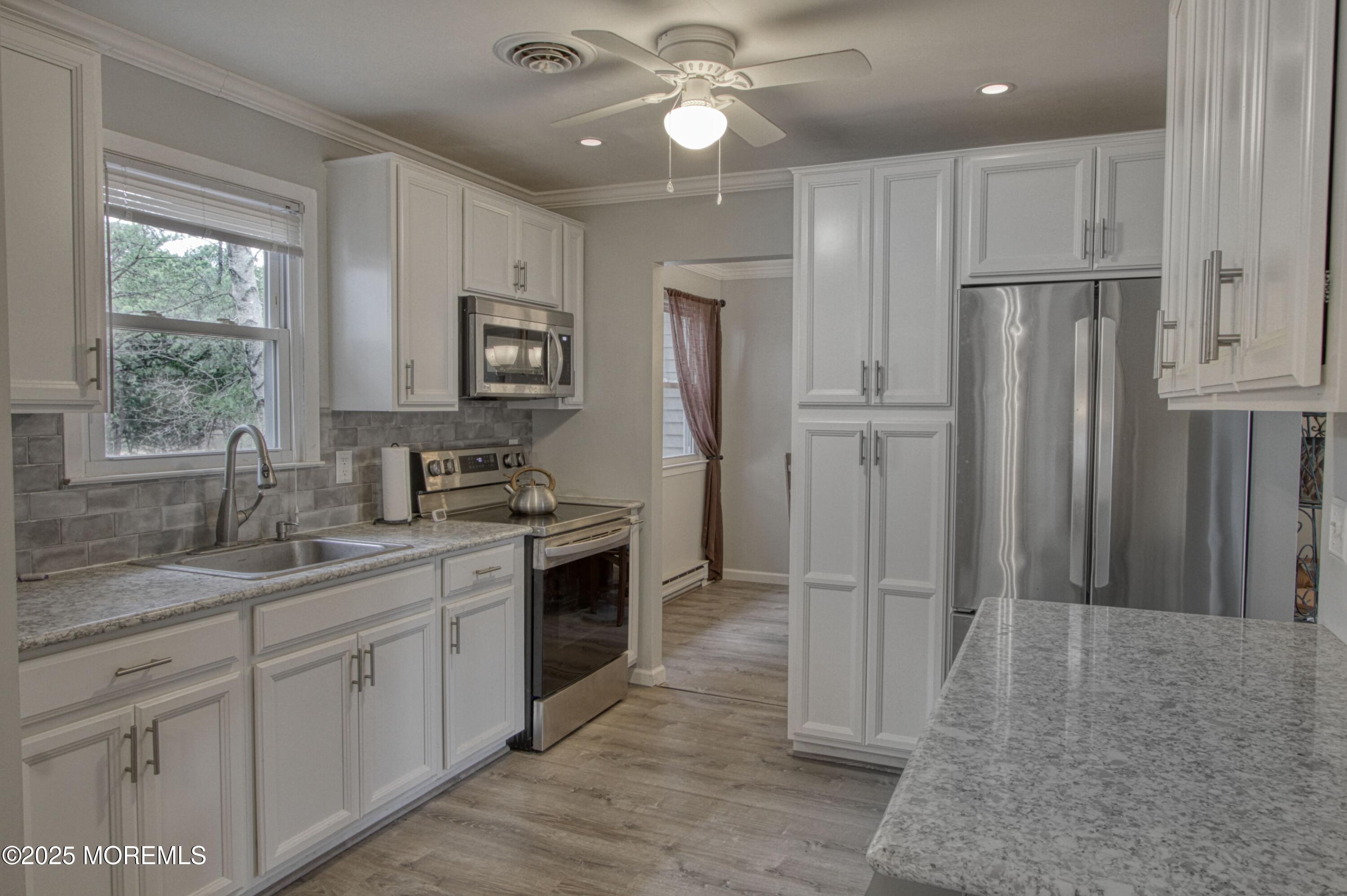 32 Augusta Road Whiting, NJ 08759 - Photo 2 of 30 a kitchen with kitchen island granite countertop a refrigerator oven a sink and dishwasher