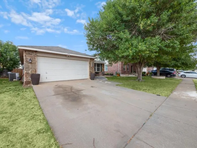 a view of a house with a yard and garage