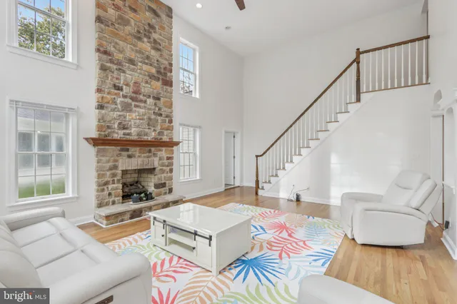 a view of a a dining room with furniture window and wooden floor