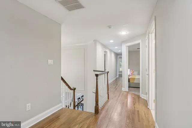 a view of an entryway with wooden floor and windows