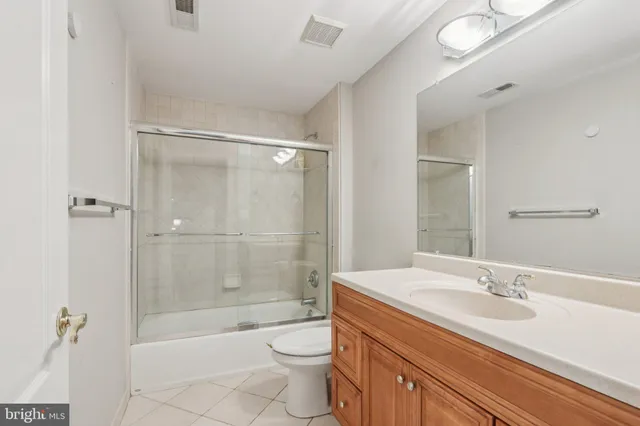 a view of a hallway with wooden floor and windows