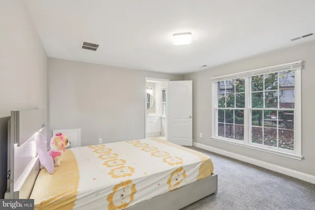 a bathroom with bathtub and window