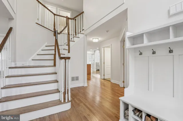 a living room with furniture a fireplace and a chandelier