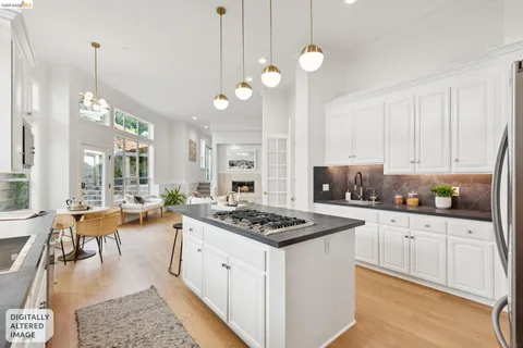 a kitchen with stainless steel appliances kitchen island granite countertop a stove a sink and a microwave