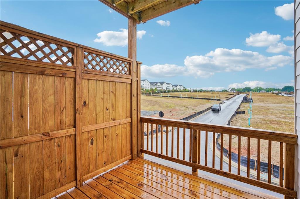 1502 Westend Way, Unit 331 Cumming, GA 30041 - Photo 11 of 38 a view of a balcony with wooden floor & fence